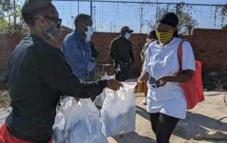 Girls in Alexander Receiving Masks and Sanitary Towels
